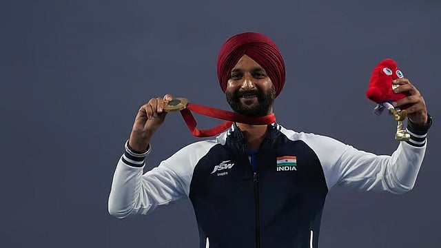 Harvinder Singh celebrates on the podium after winning the men's individual recurve archery gold medal at Paris Paralympic Games 2024. - AP